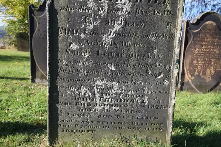 A gravestone in a graveyard
Description automatically generated with low confidence